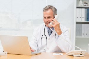 Depositphotos 39202785 Stock Photo Doctor Using Laptop And Talking